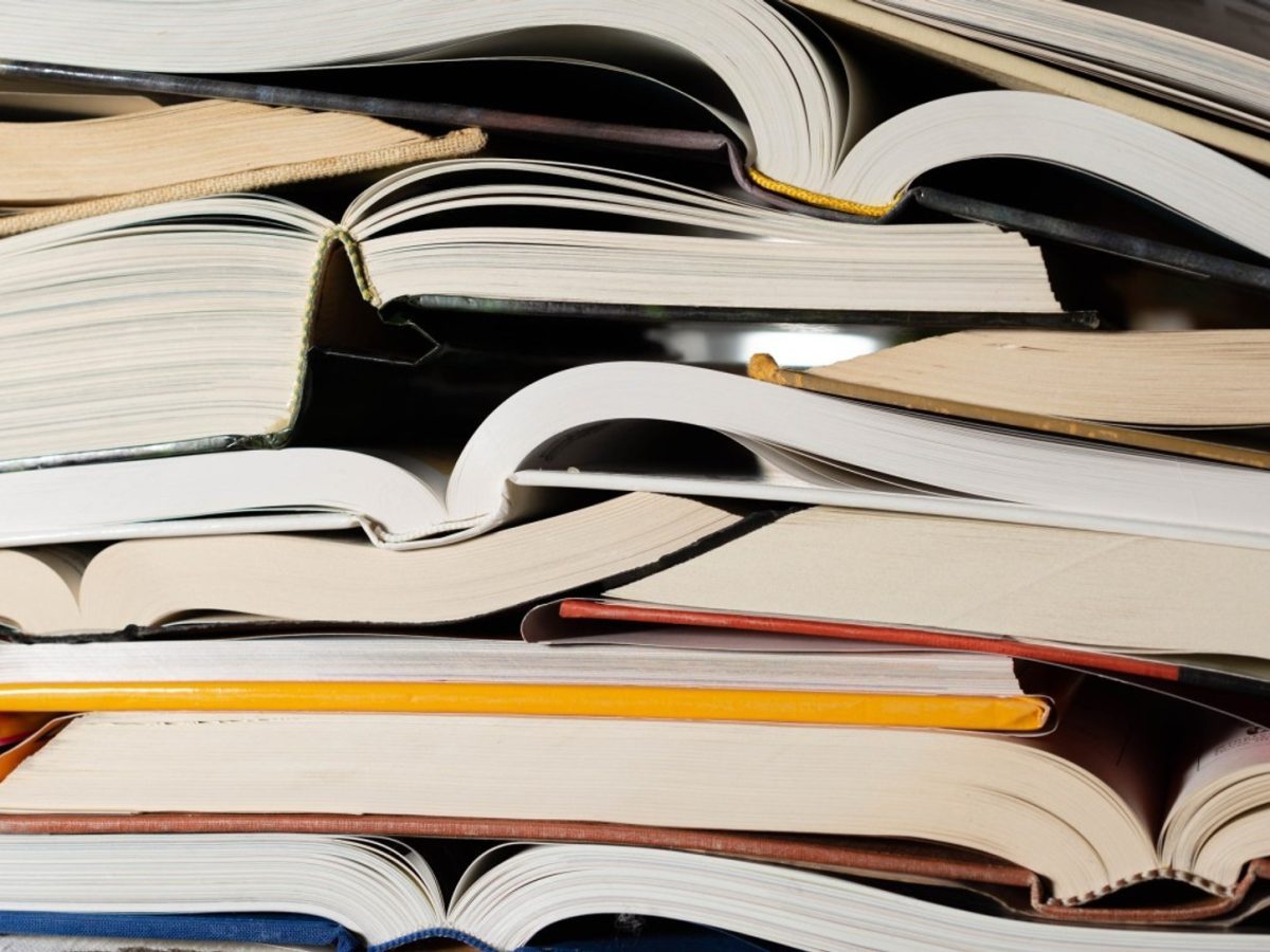 Stack of open books representing works in the Anthropic copyright settlement allocation process