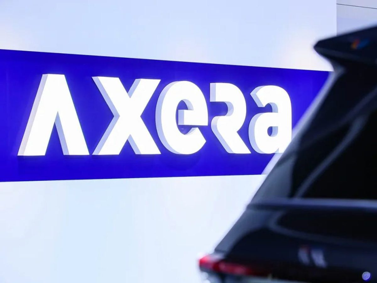 Official Axera M57 event photograph showing the Axera identity beside a vehicle for the Aptiv ADAS production milestone.