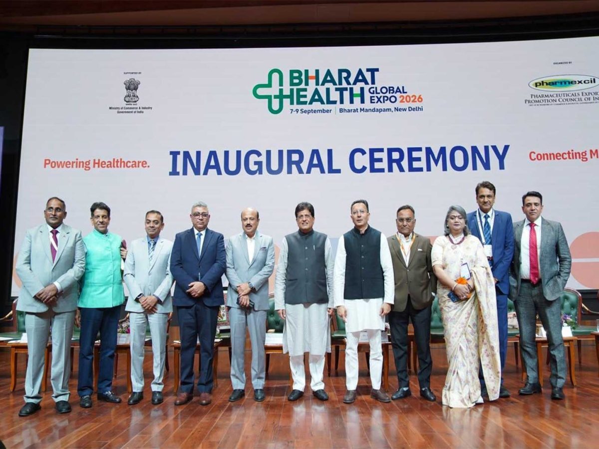 Officials stand before the Bharat Health Global Expo 2026 inaugural ceremony backdrop in New Delhi.