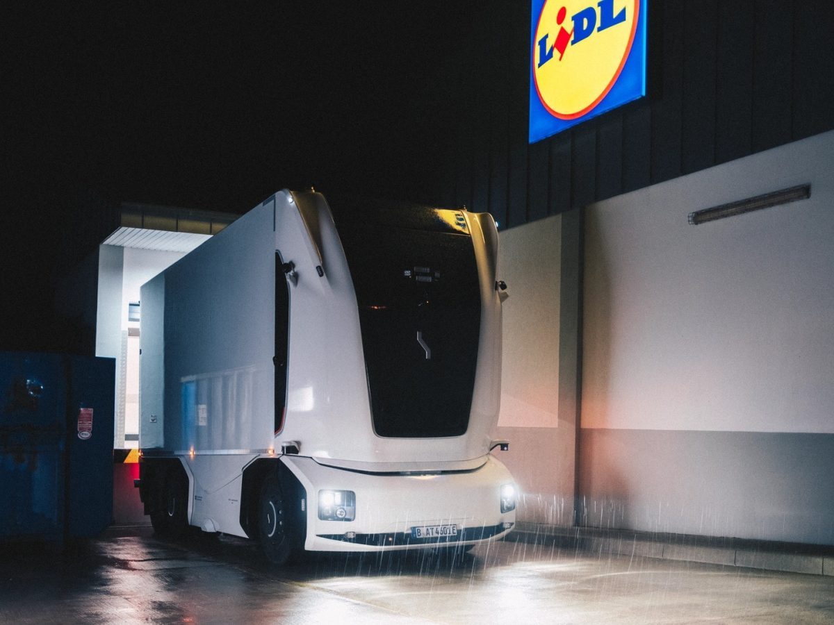 Einride Lidl autonomous truck operating beside a Lidl logistics building in the official launch photograph.