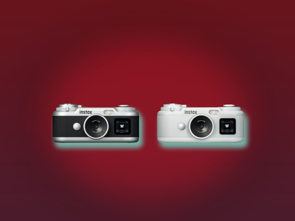Instax Pal 2 black and white cameras in an official Fujifilm product image on a deep-red editorial background.