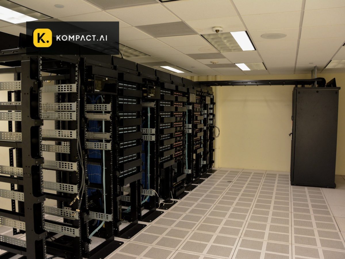 Kompact AI logo over a licensed server-room photograph illustrating CPU-first enterprise inference