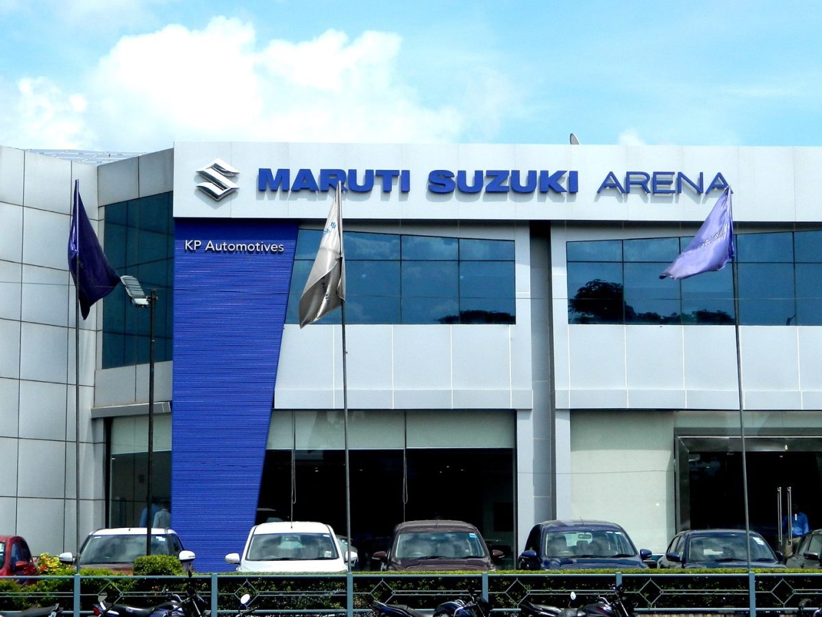 Maruti Suzuki Arena dealership exterior with multiple parked vehicles, illustrating where buyers will verify selected-model prices.