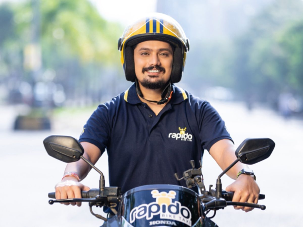 Rapido dark-pattern penalty story illustrated by an official photograph of a helmeted Rapido captain on a motorcycle