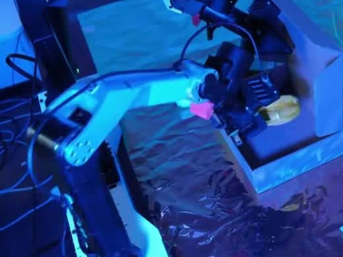 Physical robot arms run a pack-box task in Xiaomi Robotics-U0 testing
